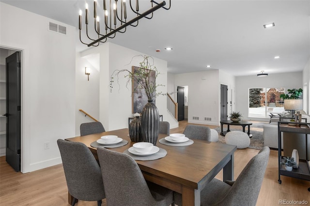 dining area featuring a chandelier and light wood-type flooring