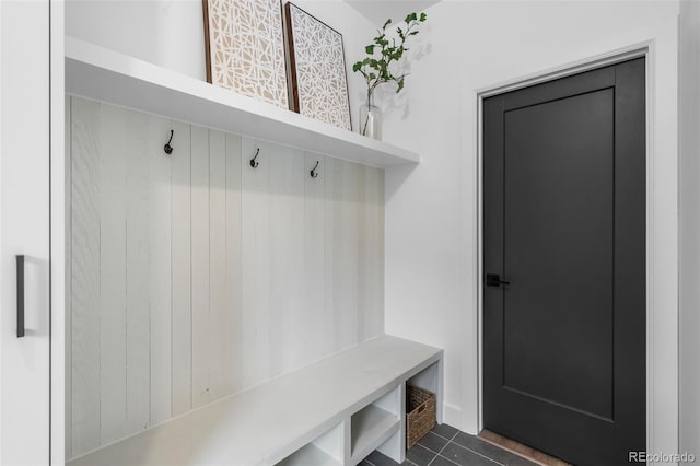 mudroom featuring dark tile patterned flooring