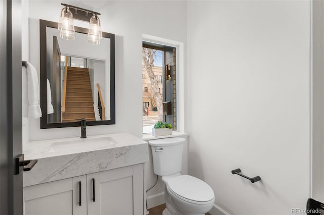 bathroom with vanity, toilet, and a wealth of natural light