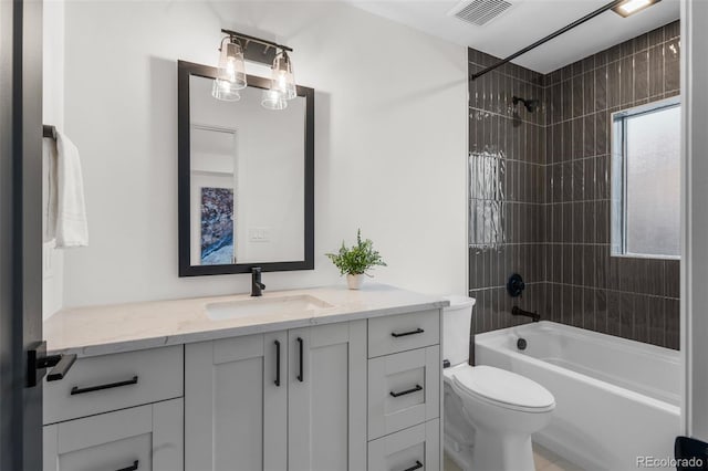 full bathroom with vanity, toilet, and tiled shower / bath combo