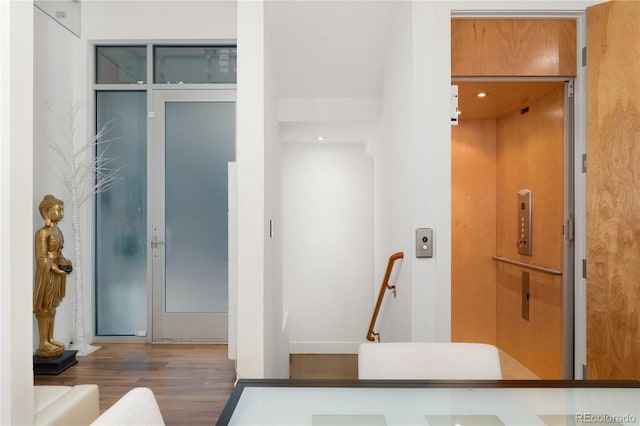 bathroom featuring elevator and hardwood / wood-style floors