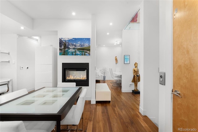 interior space featuring dark hardwood / wood-style floors and a multi sided fireplace