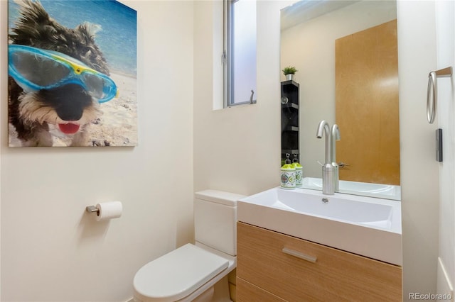 bathroom featuring toilet and vanity