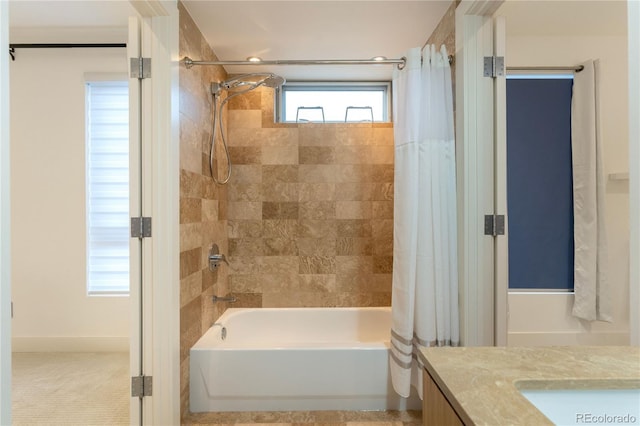 bathroom featuring shower / tub combo and vanity