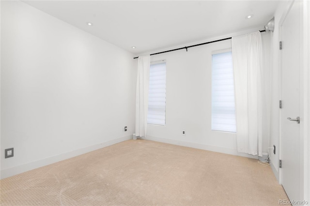 unfurnished room featuring light carpet and a healthy amount of sunlight