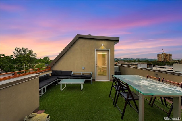 back house at dusk featuring a yard