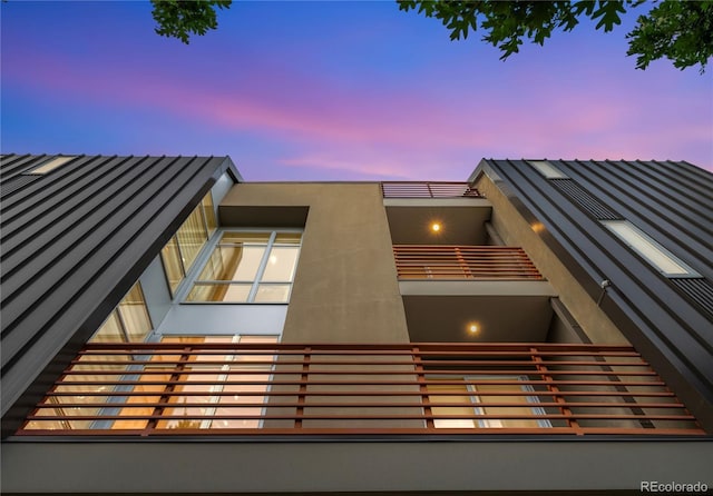 property exterior at dusk with a balcony