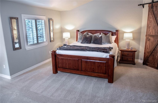 carpeted bedroom with a barn door