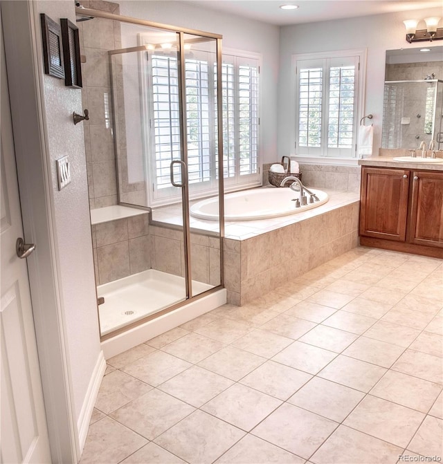 bathroom featuring vanity, tile patterned flooring, and separate shower and tub