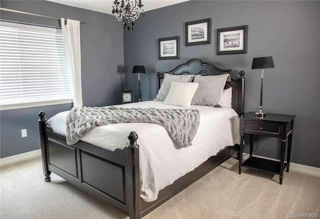 bedroom with light carpet and an inviting chandelier