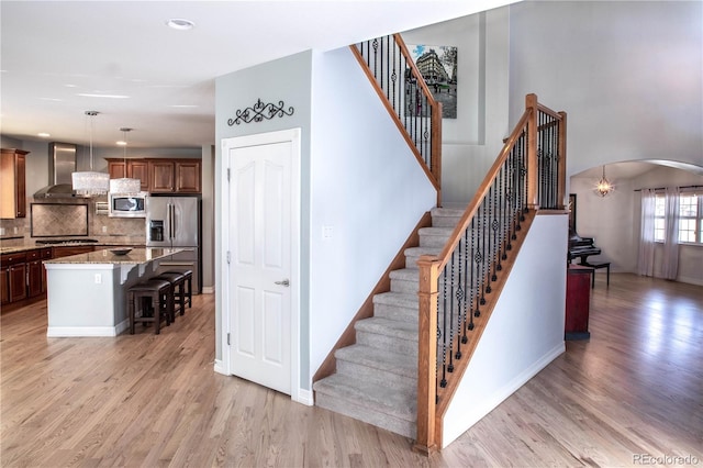 staircase with hardwood / wood-style floors