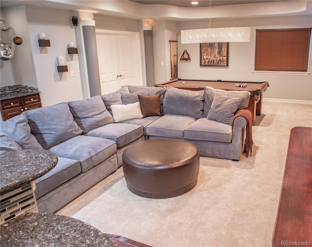 living room with a raised ceiling, light colored carpet, and billiards