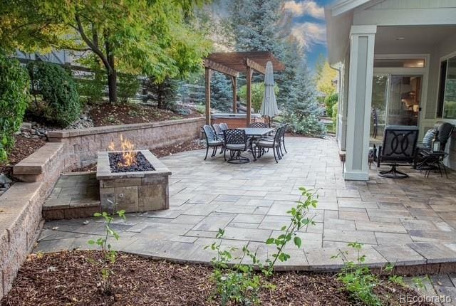 view of patio / terrace with a pergola and a fire pit