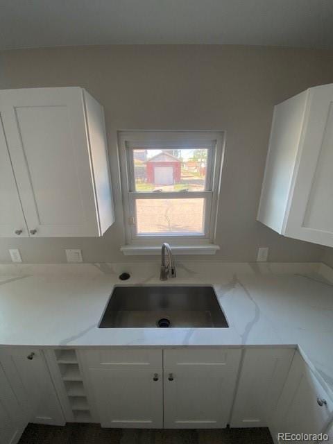 521 10th St, Fort Lupton, CO 80621 - kitchen featuring a sink and white cabinetry