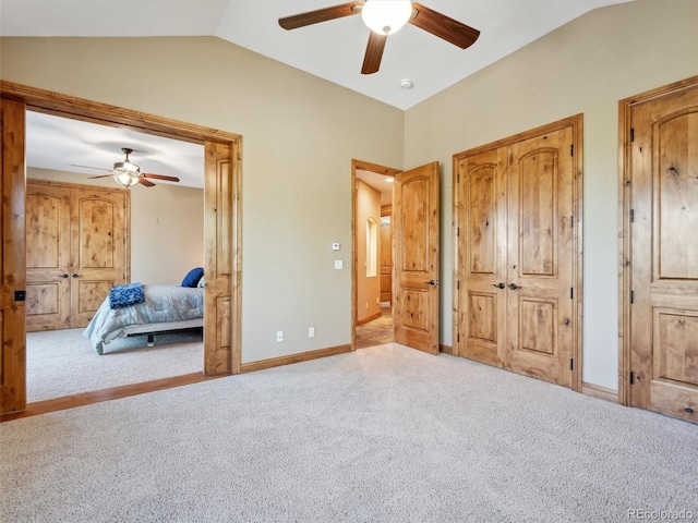 bedroom featuring lofted ceiling, carpet flooring, baseboards, and ceiling fan