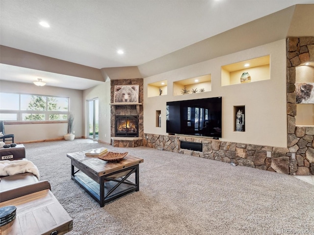 living area featuring a stone fireplace, recessed lighting, baseboards, and carpet floors