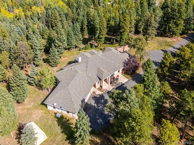 birds eye view of property with a wooded view