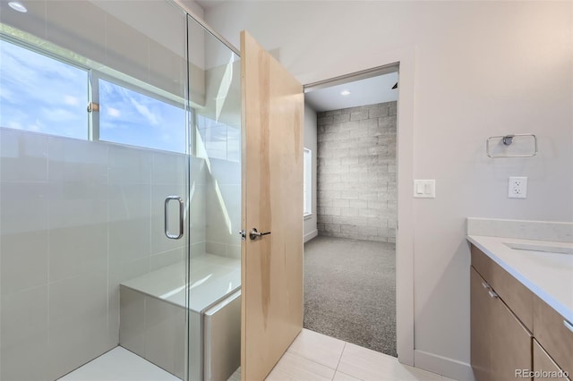 bathroom featuring tile patterned flooring, vanity, and an enclosed shower