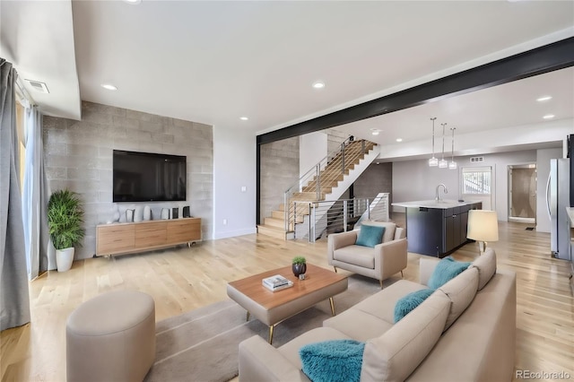 living room with hardwood / wood-style flooring and sink