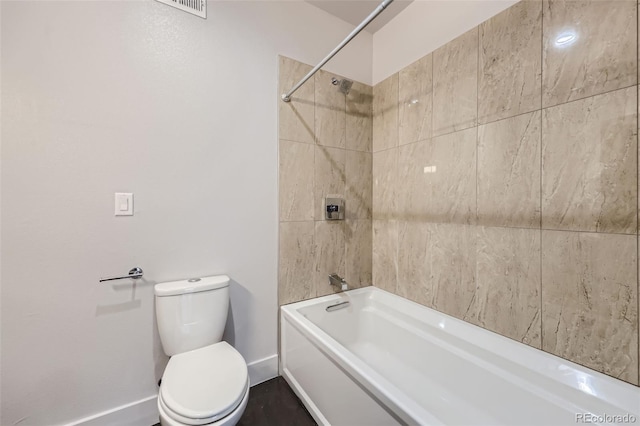 bathroom featuring tiled shower / bath and toilet