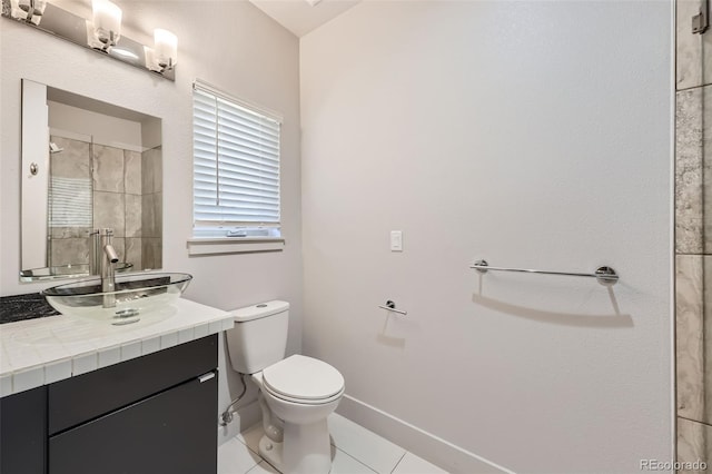 bathroom featuring tile patterned flooring, vanity, and toilet