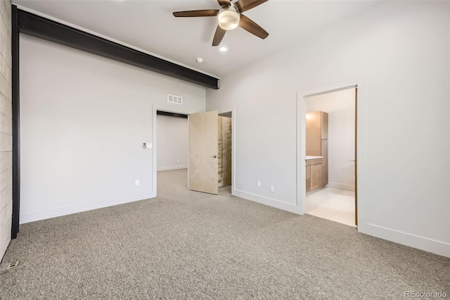 unfurnished bedroom featuring ensuite bath and ceiling fan