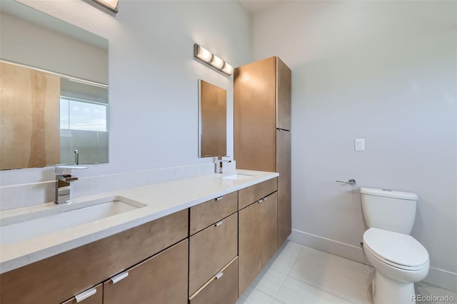 bathroom featuring tile patterned flooring, vanity, and toilet