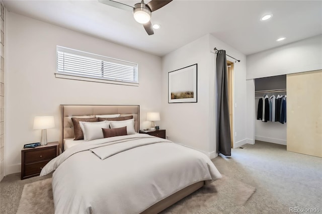 bedroom featuring ceiling fan, a closet, and light carpet