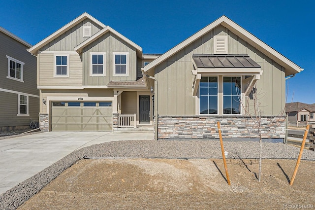 view of front of home featuring board and batten siding, metal roof, stone siding, driveway, and a standing seam roof