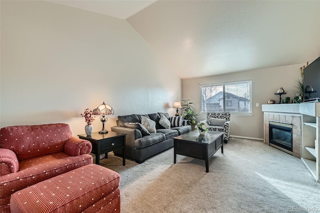 carpeted living room featuring lofted ceiling and a tiled fireplace