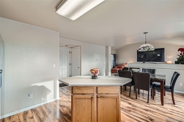 kitchen featuring light hardwood / wood-style flooring, pendant lighting, and a center island