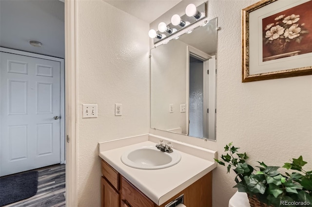 bathroom featuring hardwood / wood-style floors and vanity