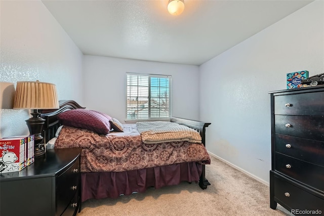 bedroom featuring light colored carpet