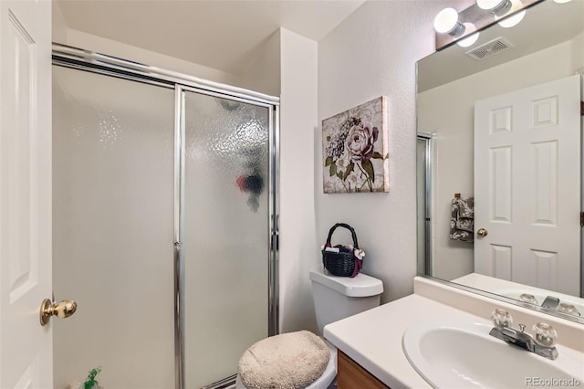 bathroom featuring toilet, walk in shower, and vanity