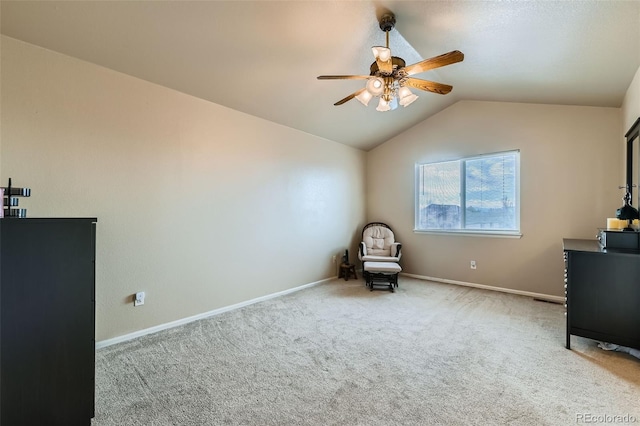 unfurnished room with light colored carpet, ceiling fan, and vaulted ceiling