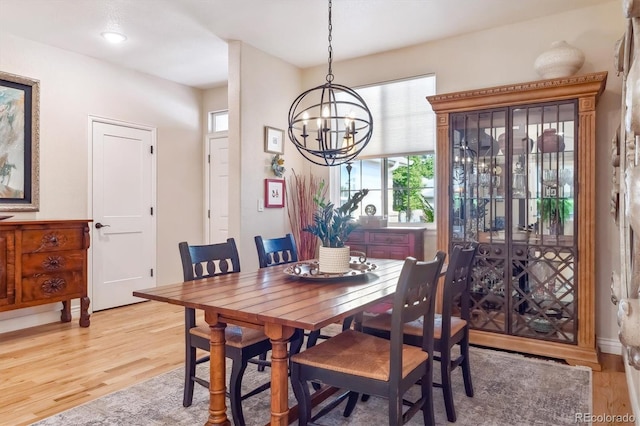 1026 Deer Clover Way, Castle Pines, CO 80108 - dining area featuring light wood-style flooring and a chandelier