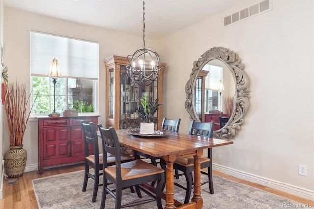 1026 Deer Clover Way, Castle Pines, CO 80108 - dining room with a chandelier, wood finished floors, and baseboards