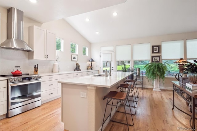 1026 Deer Clover Way, Castle Pines, CO 80108 - kitchen featuring electric stove, wall chimney exhaust hood, white cabinetry, a sink, and lofted ceiling