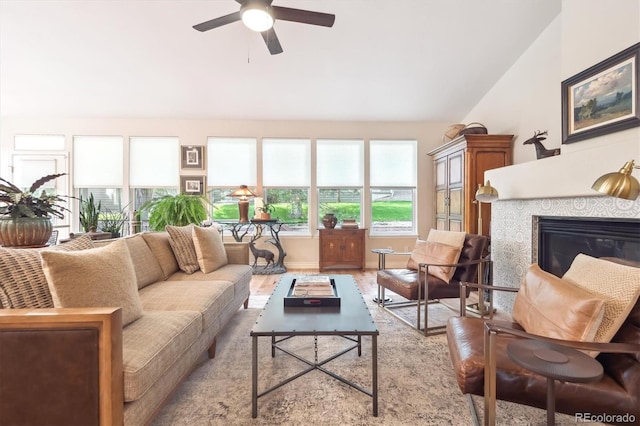 1026 Deer Clover Way, Castle Pines, CO 80108 - living area with wood finished floors, a ceiling fan, lofted ceiling, and a tile fireplace