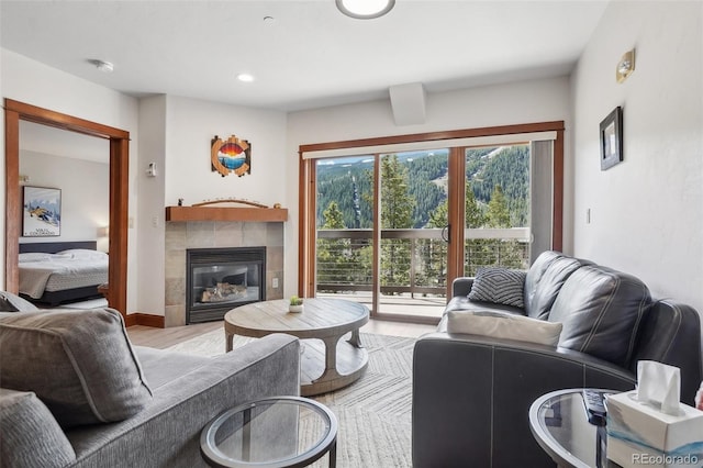 22787 US Highway 6 Unit 302, Keystone, CO 80435 - living room with light wood-type flooring, a tile fireplace, and recessed lighting