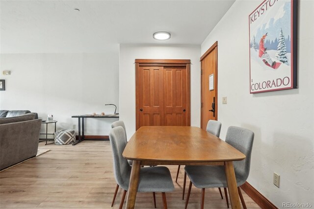 22787 US Highway 6 Unit 302, Keystone, CO 80435 - dining space featuring light wood finished floors and baseboard heating