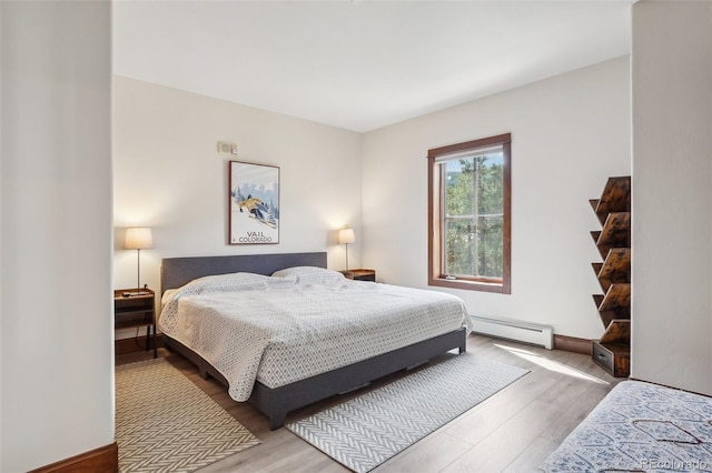 22787 US Highway 6 Unit 302, Keystone, CO 80435 - bedroom featuring baseboard heating and wood finished floors
