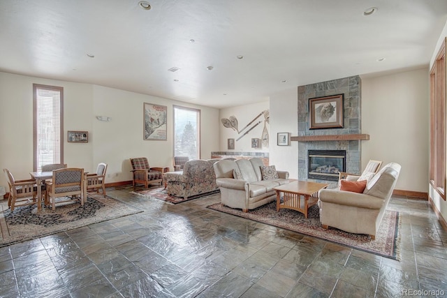 22787 US Highway 6 Unit 302, Keystone, CO 80435 - living room with stone tile floors, a tiled fireplace, and recessed lighting