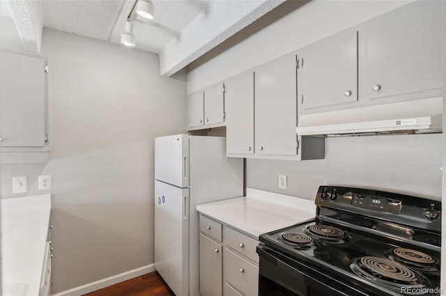 kitchen featuring black electric range, light countertops, white cabinets, and range hood