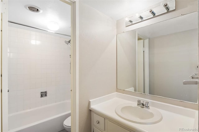 bathroom featuring toilet,  shower combination, and vanity