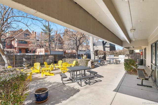 view of patio / terrace with a residential view, fence, and outdoor dining area