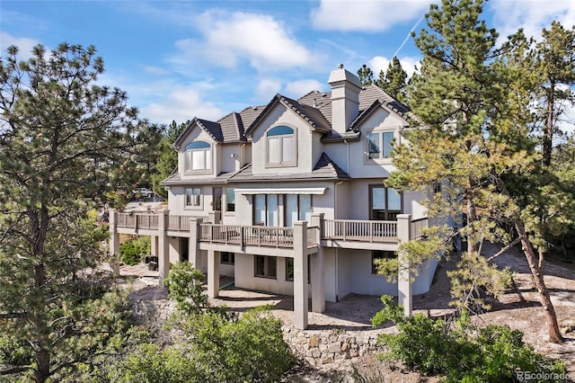 back of house with a wooden deck