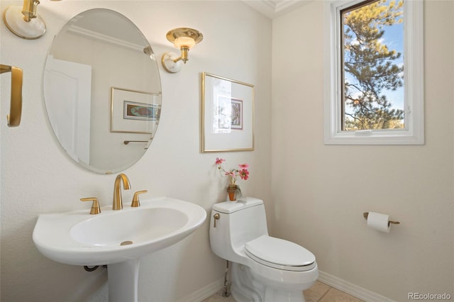 bathroom featuring tile patterned floors, sink, ornamental molding, and toilet