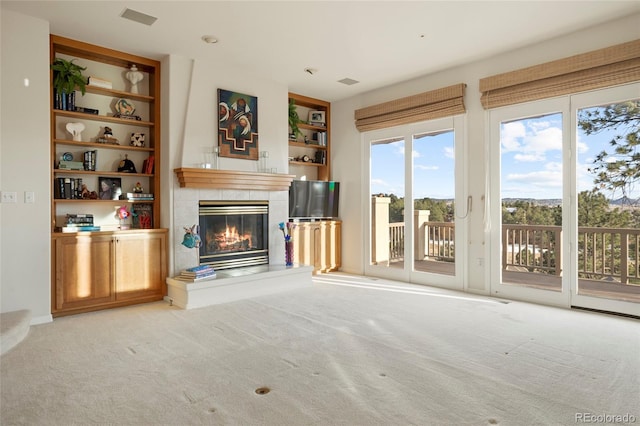 unfurnished living room with a fireplace and light carpet