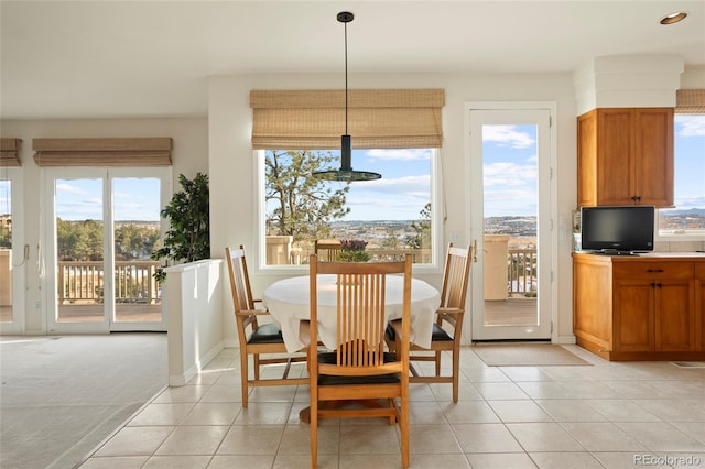 dining area featuring light tile patterned floors